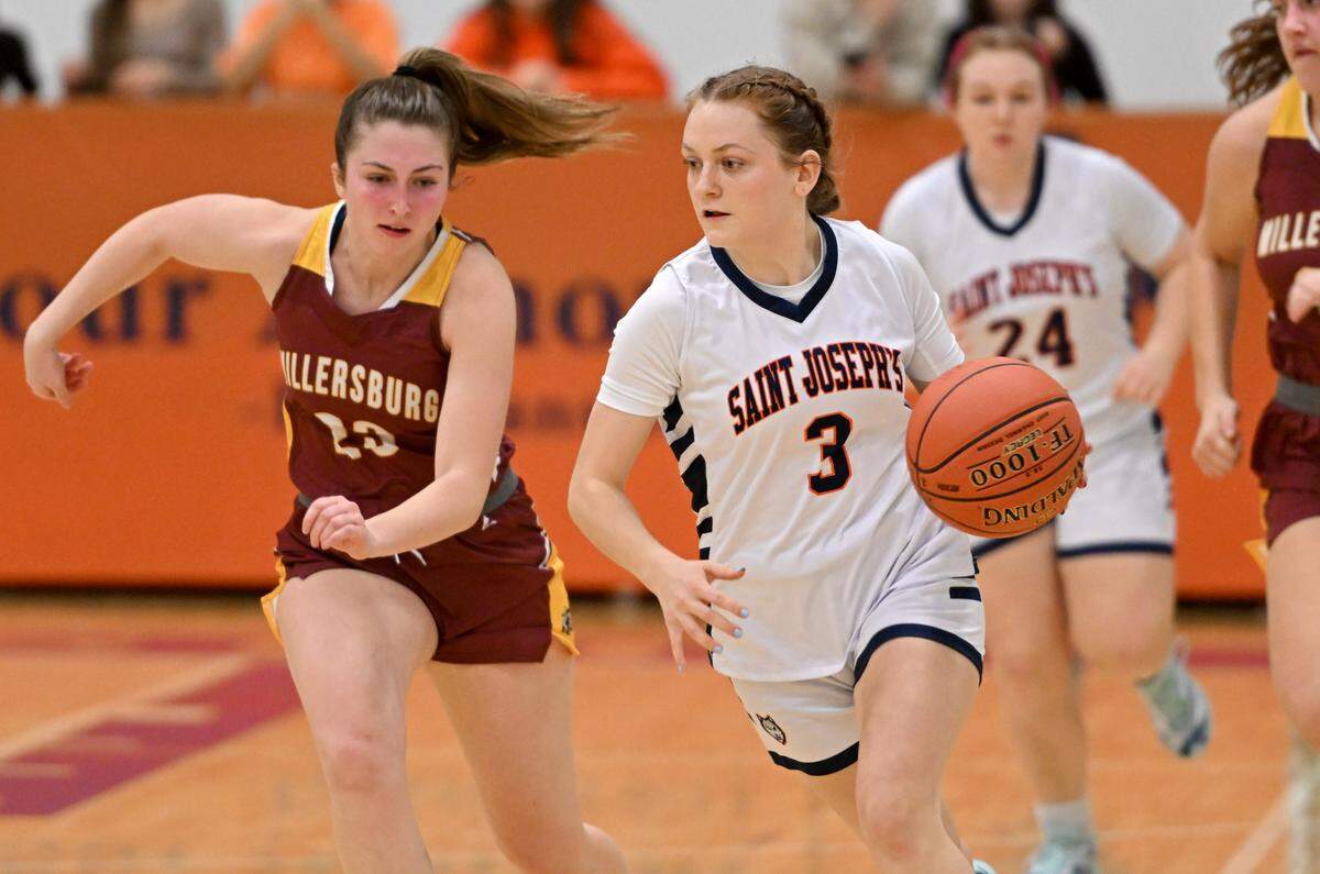 Saint Joseph’s Naomi Crispin dribbles down the court with the ball ahead of a Millersburg defender during the game on Wednesday, Jan. 17, 2024.