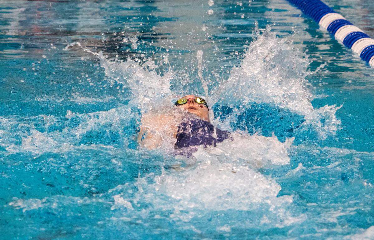 State College Area High School senior Jade Castro surfaces for air during the Girls 100 Yard Backstroke in the AAA Bracket during the PIAA Swimming and Diving 2023 District 6 Championship held at the McCoy Natatorium on Saturday, March 4, 2023, in University Park, Pa. Castro placed first in her event with a final time of 0:55.16.