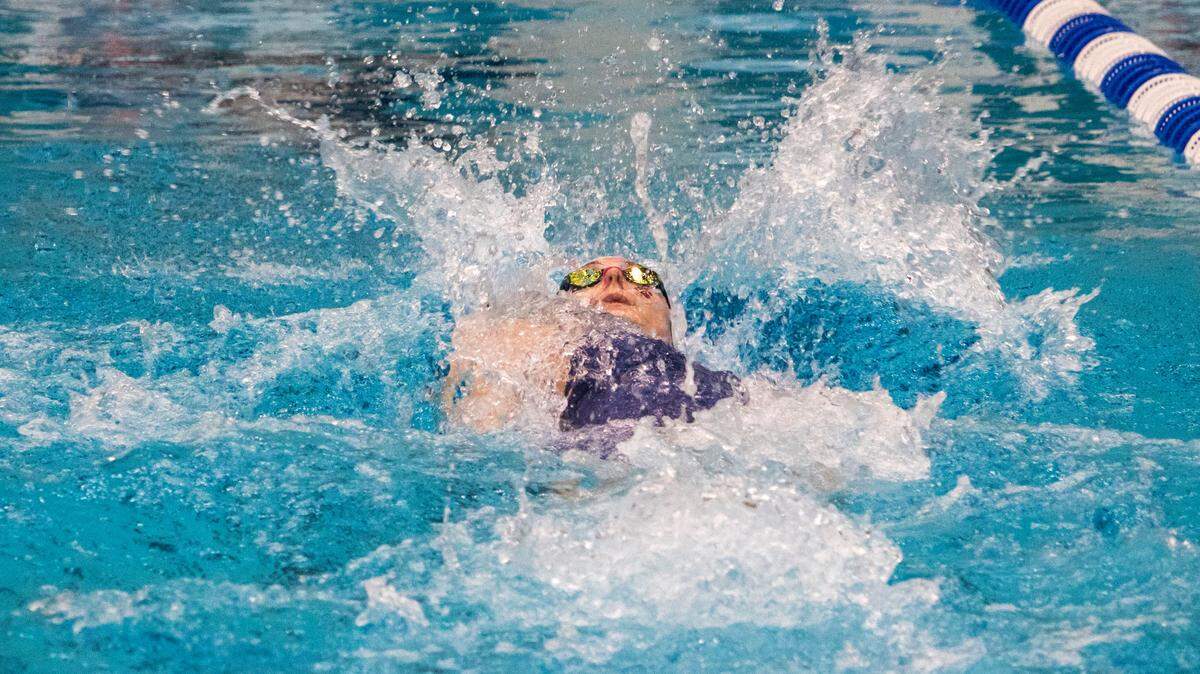 State College Area High School senior Jade Castro surfaces for air during the Girls 100 Yard Backstroke in the AAA Bracket during the PIAA Swimming and Diving 2023 District 6 Championship held at the McCoy Natatorium on March 4. Castro took home gold, two silvers and a bronze medal in the PIAA Class 3A state championships.