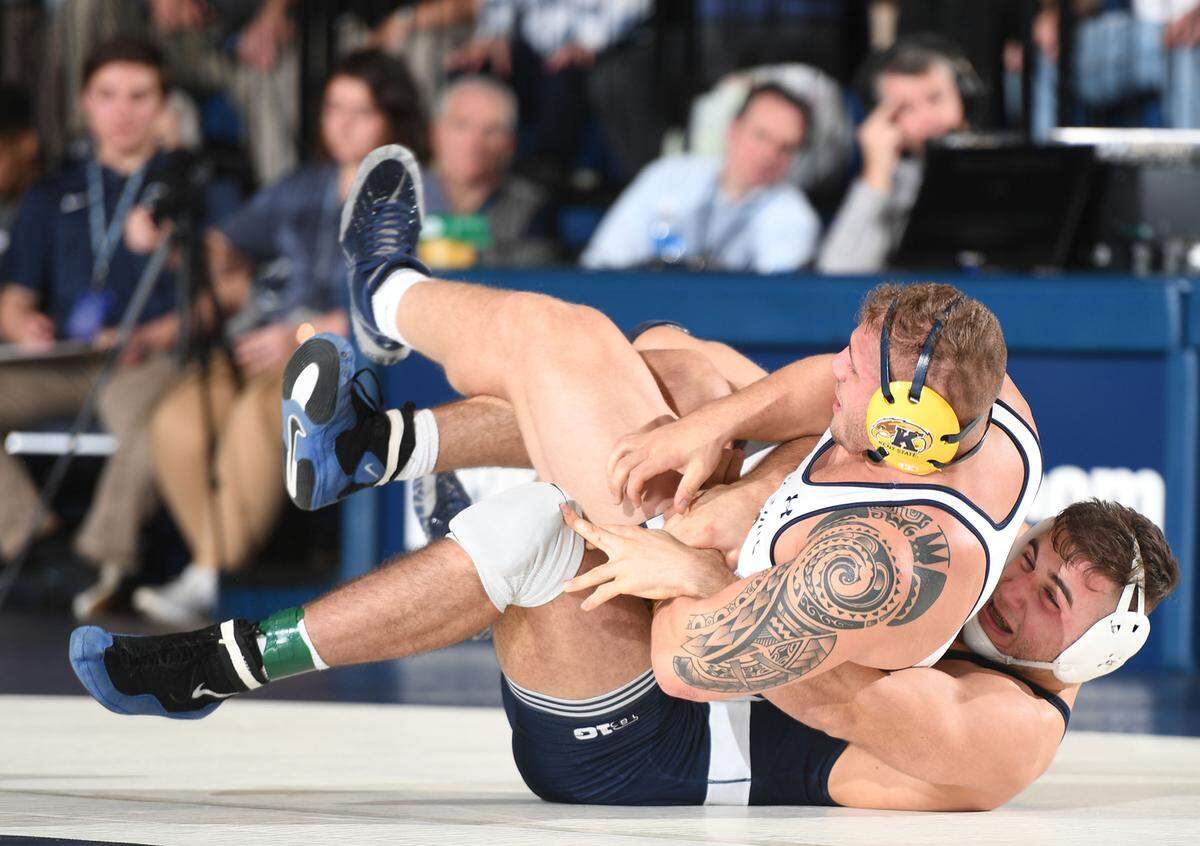 Penn State’s Anthony Cassar, 285 lbs, takes down Kent State’s Billy Bolia Sunday at Rec Hall in State College. Cassar won by technical fall. Penn State defeated Kent State, 52-3.