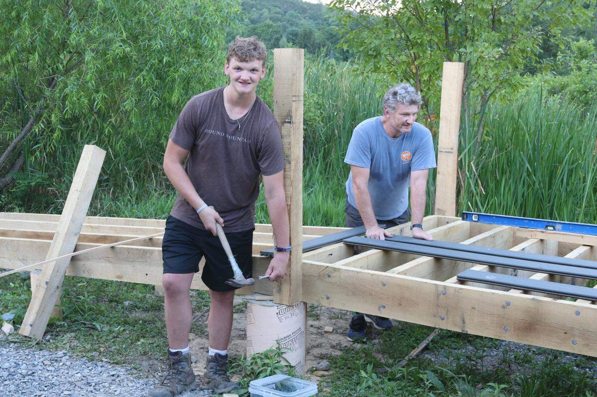Boy Scout Will English, left, works on the viewing platform with his father Chris on July 21. The Eagle Scout project is being constructed on Wildlife for Everyone Foundation wetlands at Miles Hollow Road.