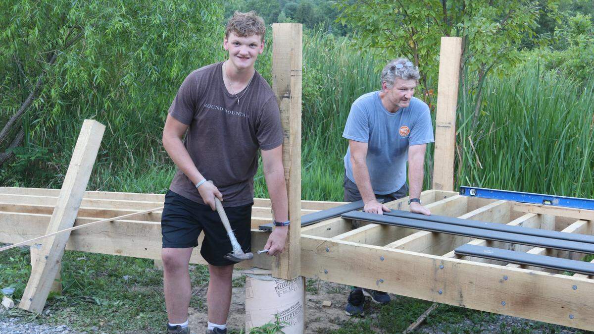 Boy Scout Will English, left, works on the viewing platform with his father Chris on July 21. The Eagle Scout project is being constructed on Wildlife for Everyone Foundation wetlands at Miles Hollow Road.