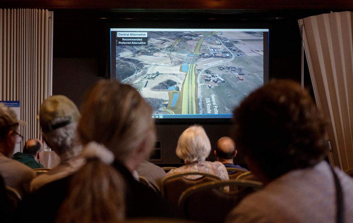Community members watch a video about the central alternative route for the State College Area Connector project during PennDOT’s public scoping meeting on Thursday, May 9, 2025 at the Wyndham Garden State College.