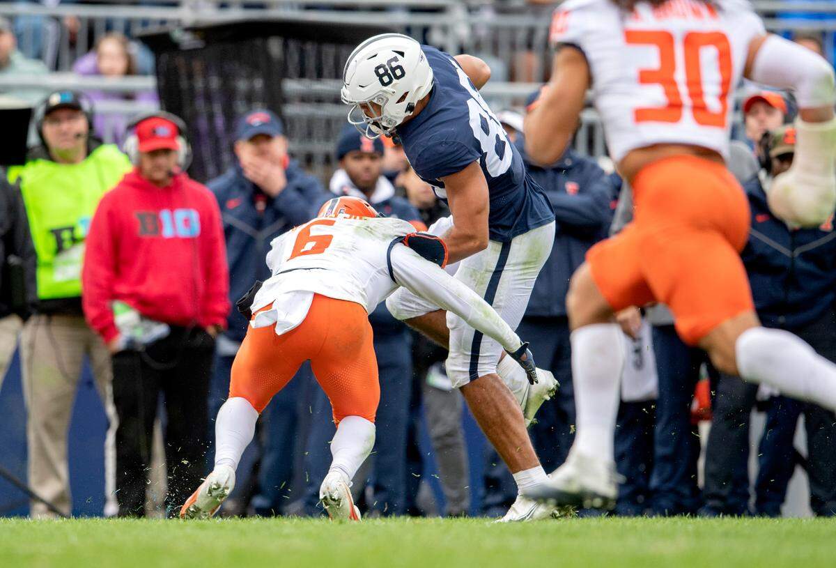 Illinois defensive back Tony Adams stops Penn State tight end Brenton Strange after he makes a catch in the first overtime of the game on Saturday, Oct. 23, 2021.