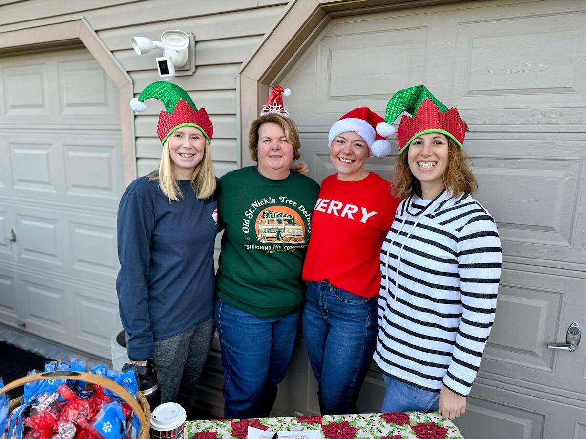 From left: Maddie Lee, Kelly Rhoades, Ashley Molek and Connie Stanton volunteer to prepare Christmas gifts that are destined for more than 220 Centre County children.