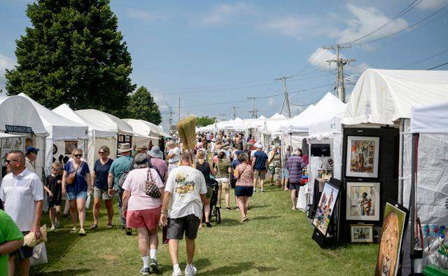 Visitors browse the artists at the People’s Choice Festival on Friday, July 14, 2023.