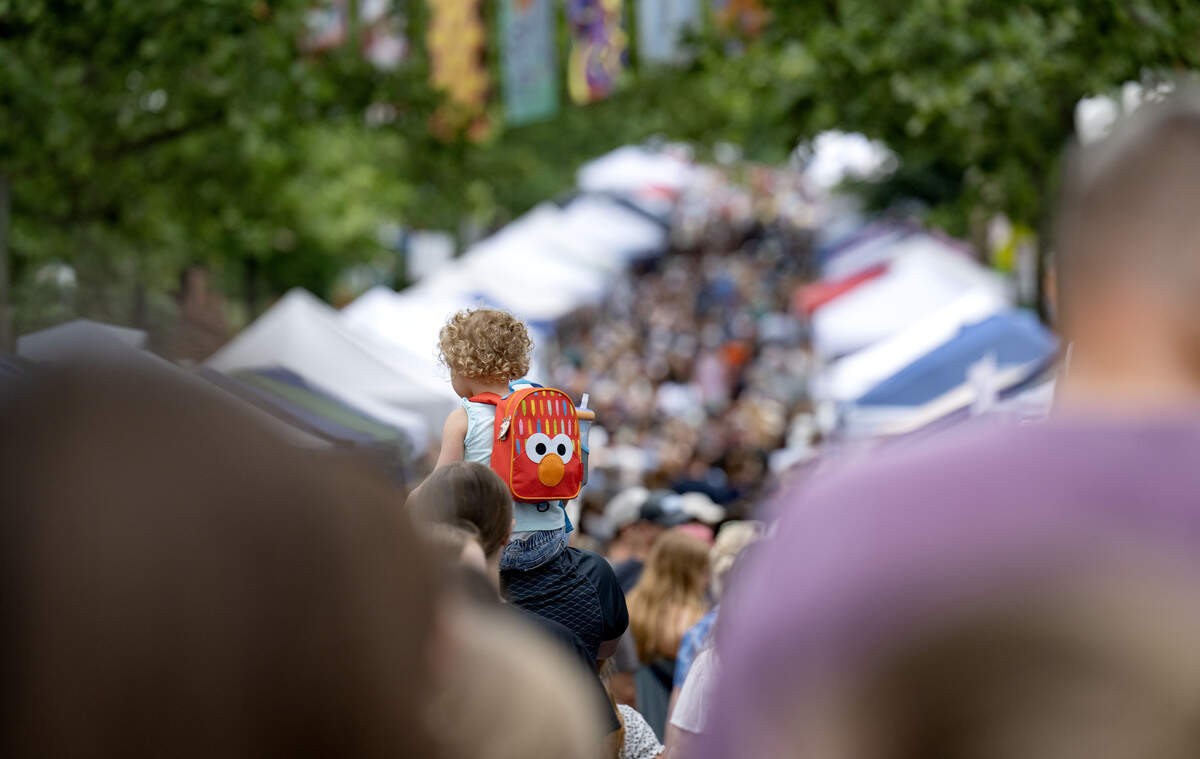 A youngster gets a better view at the Children and Youth Day sidewalk sale at the Central Pennsylvania Festival of the Arts on Wednesday, July 8, 2026.