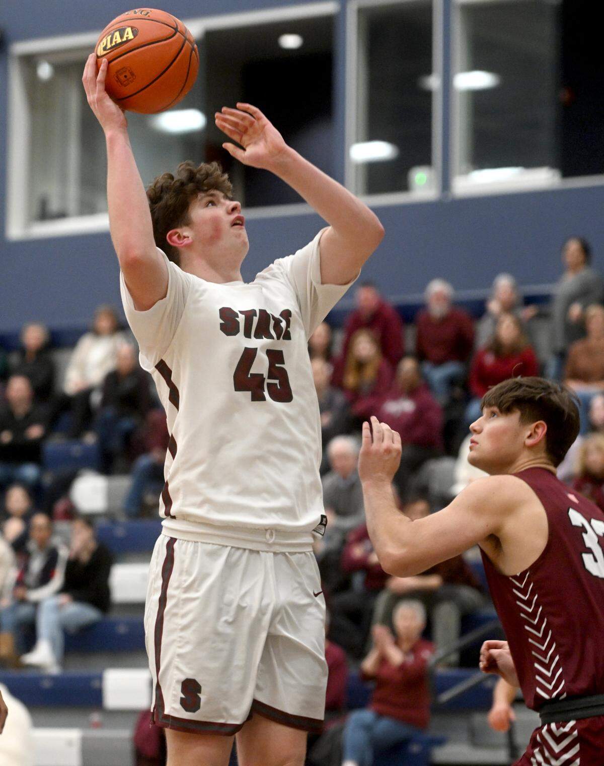 State College’s Kevin McKenna shoots for a basket over Altoona defenders during the District 6 6A championship game at Mount Aloysius College on Friday, Feb. 24, 2023.