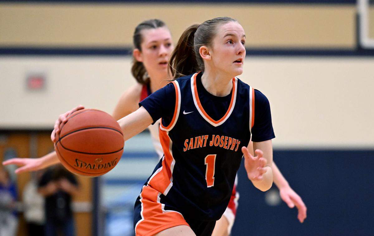 Saint Joseph’s Catholic Academy’s Alexia Luckovich dribbles down the court with the ball from DuBois Central Catholic defenders during the game on Wednesday, March, 12, 2025 at Bald Eagle Area High School.