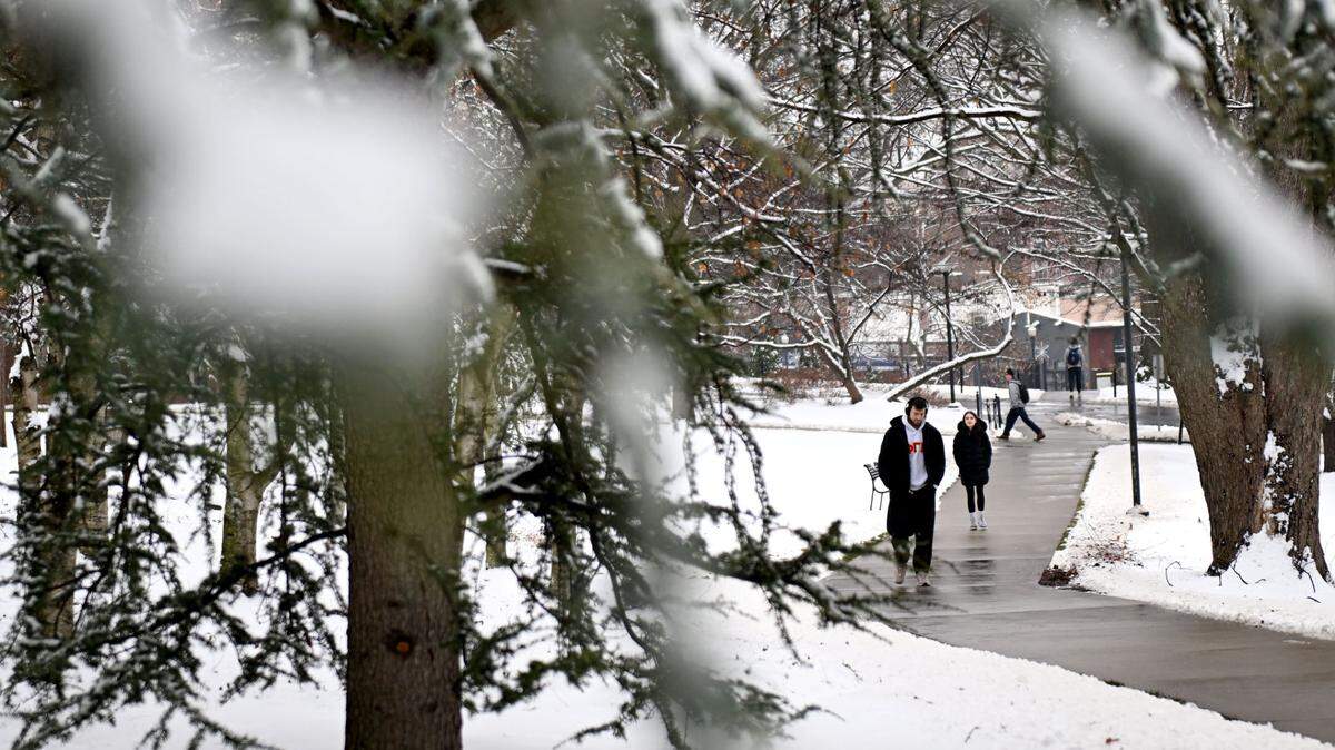 Students walk on the Penn State campus in the snow for the first day of finals on Monday, Dec. 16, 2024.