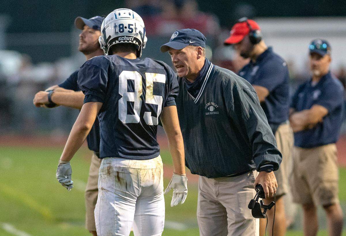 Penns Valley football coach Martin Tobias talks to Tanner Ilgen during the game against Philipsburg-Osceola on Friday, Sept. 17, 2021.