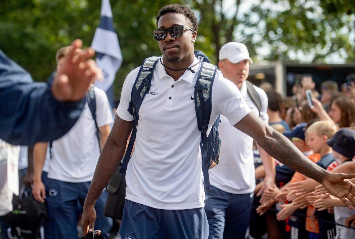 Penn State cornerback Joey Porter Jr. high fives fans as the team arrives at Beaver Stadium for the home opener against Ohio on Saturday, Sept. 10, 2022.