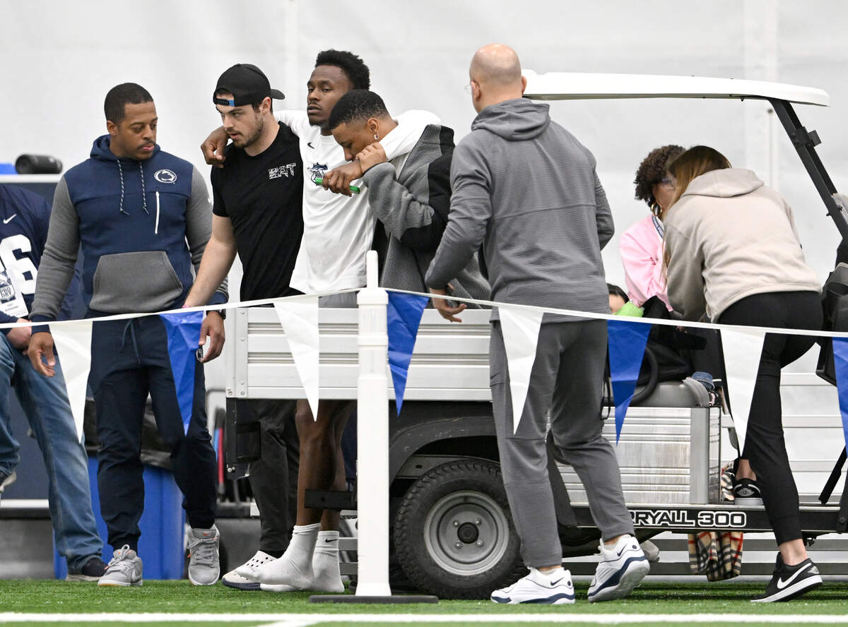 Trace McSorley and Saquon Barkley help DaeSean Hamilton onto a medical cart during Penn State’s Pro Day on Friday, March 15, 2024 in Holuba Hall. Hamilton was running routes for NFL scouts.