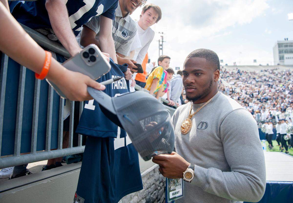 Former Penn State stand out and current Dallas Cowboy Micah Parsons signs autographs for fans during the Blue-White game on Saturday, April 23, 2022.