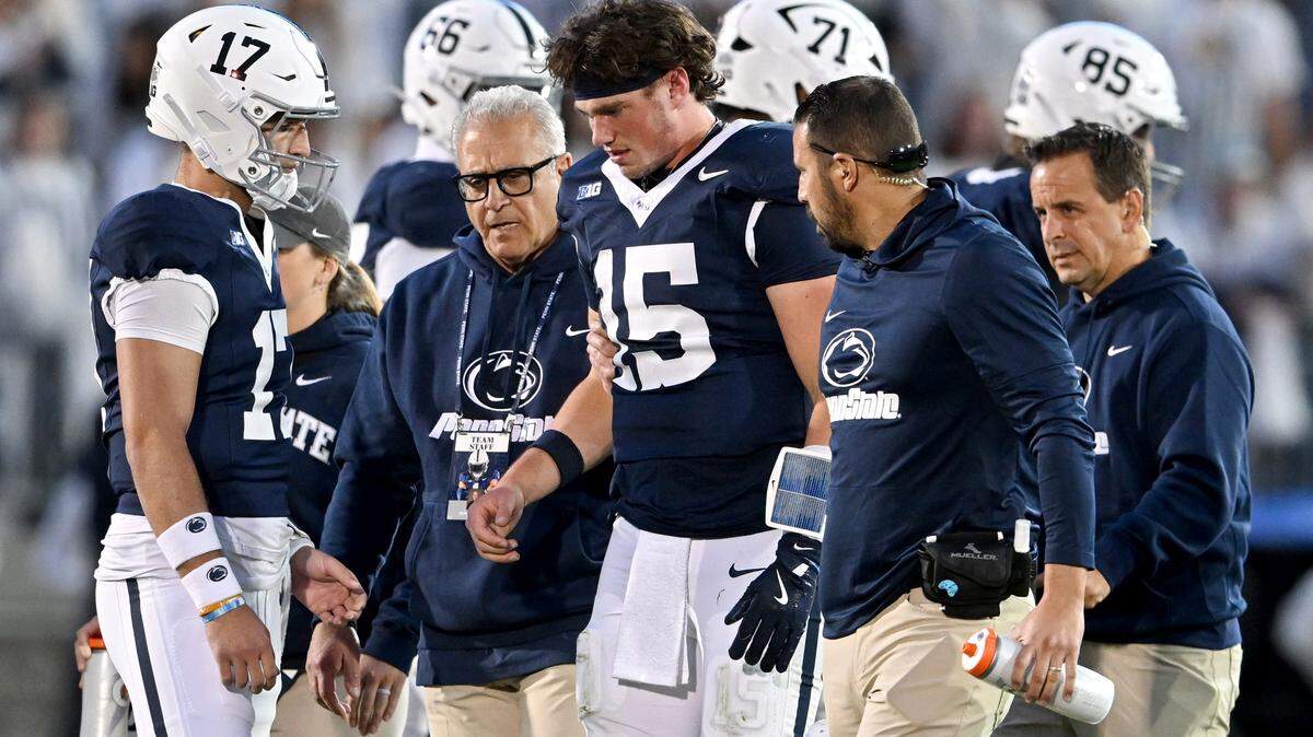 Dr. Wayne Sebastianelli walks with quarterback Drew Allar and trainers after he was injured during the Penn State football game against Northwestern on Saturday, Oct. 11, 2025.  