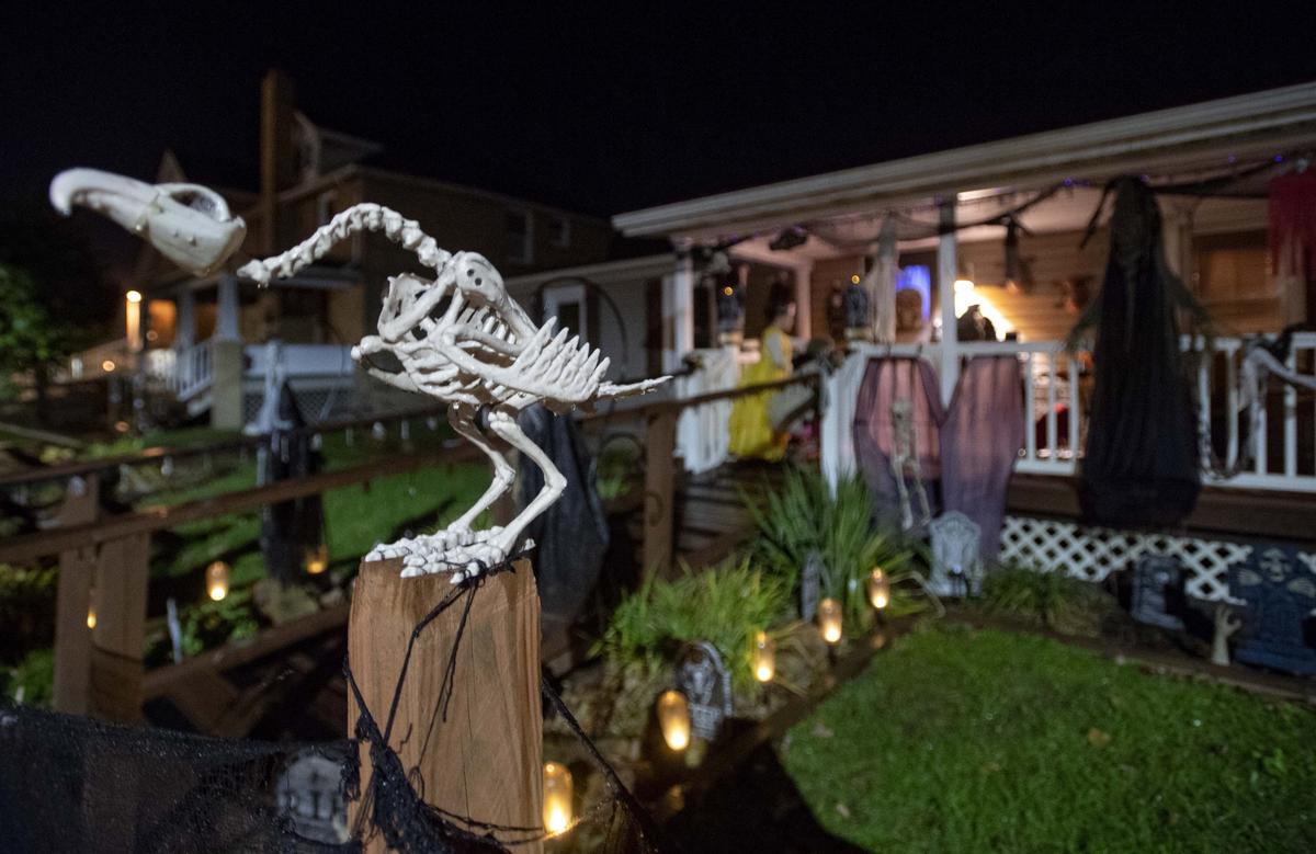 Trick-or-treaters venture up to the porch of Tina Hemmis’ spooky decorated house in Port Matilda on Halloween 2018.