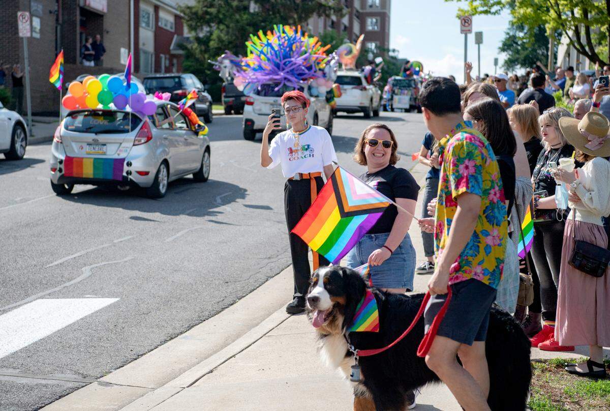 People line the sidewalk to cheer on the State College Pride Ride along Fraser Street on Saturday, June 12, 2021.