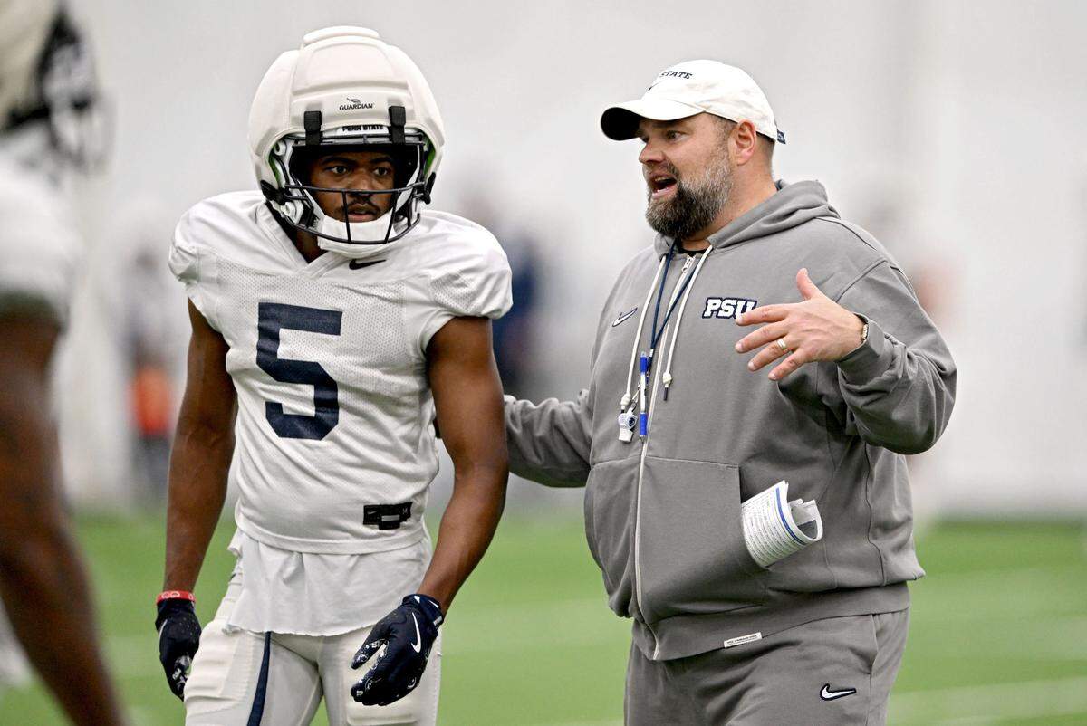 Penn State wide receiver Devonte Ross talks with offensive coordinator Andy Kotelnicki during spring football practice on Tuesday, April 1, 2025.