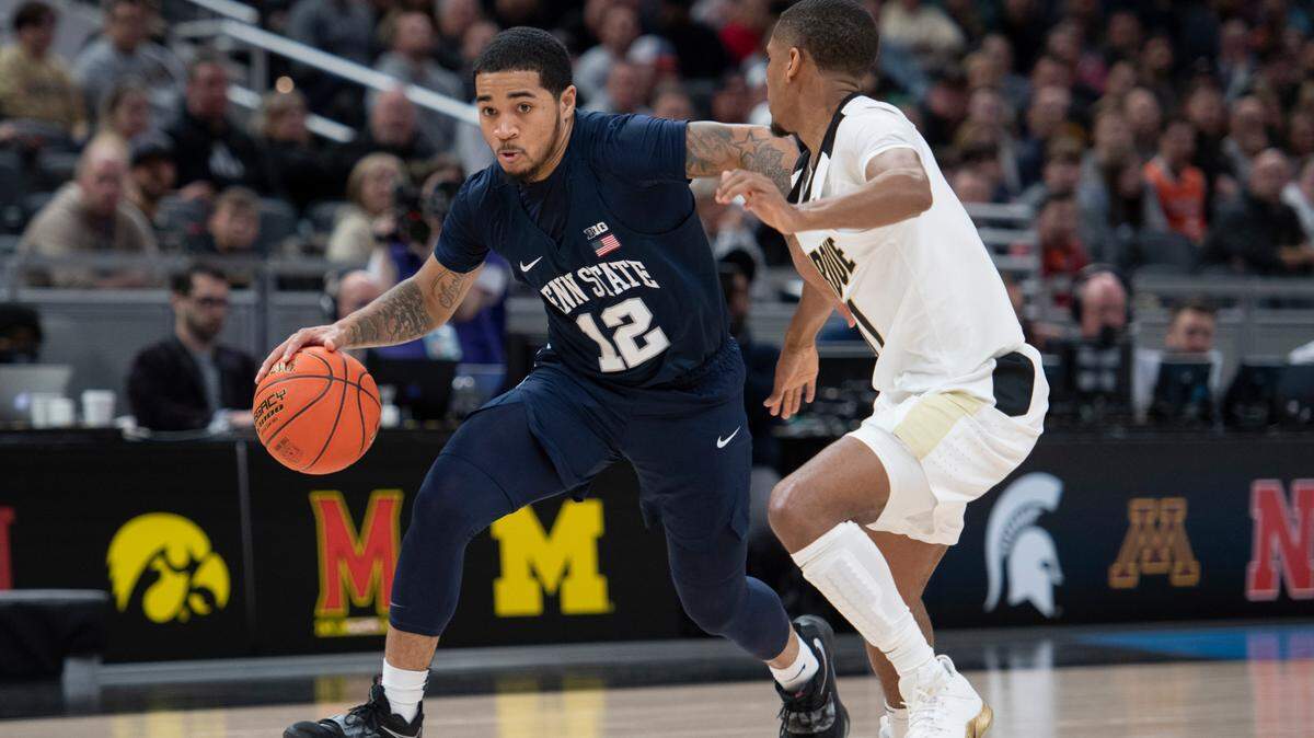 Penn State guard Sam Sessoms (12) dribbles past Purdue guard Isaiah Thompson (11) during the Big Ten Tournament quarterfinals March 11 at Gainbridge Fieldhouse in Indianapolis. Penn State fell to Purdue 69-61 in the tournament’s quarterfinal game.