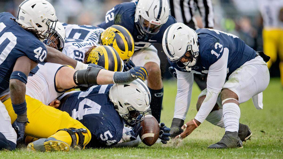 Penn State defensive tackle Derrick Tangelo dives to the ball after a Michigan fumble during the game on Saturday, Nov. 13, 2021.