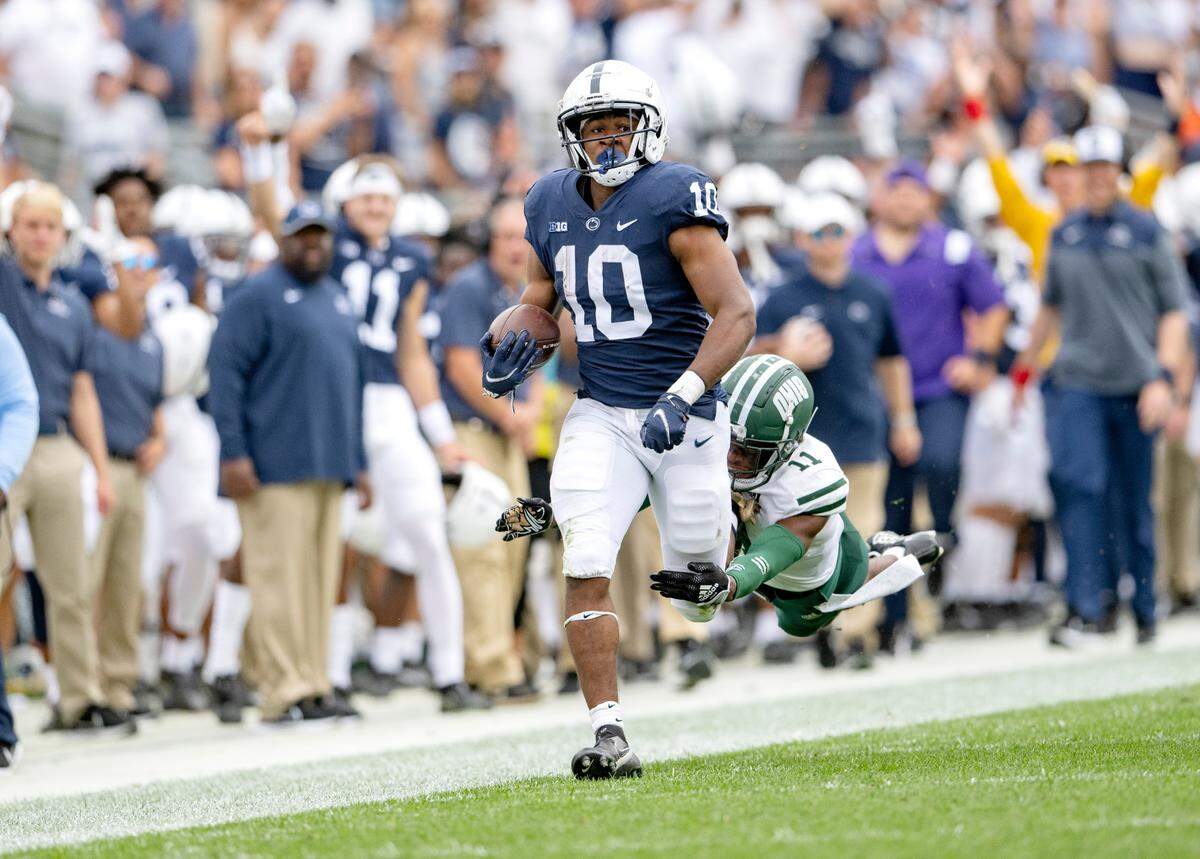 Ohio’s Tariq Drake dives after Penn State running back Nicholas Singleton as he runs with the ball during the game on Saturday, Sept. 10, 2022.