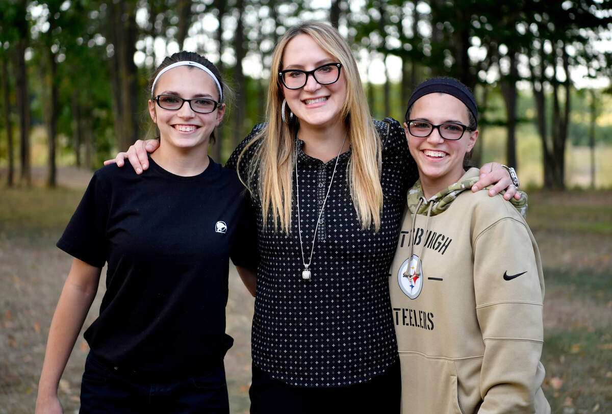 Morgan, left, and Megan Marko, right, laugh with Randi Twoey on Thursday, Aug. 20, 2020. Twoey organized a benefit concert for the twins, who both have epilepsy, to raise money for a seizure response dog.