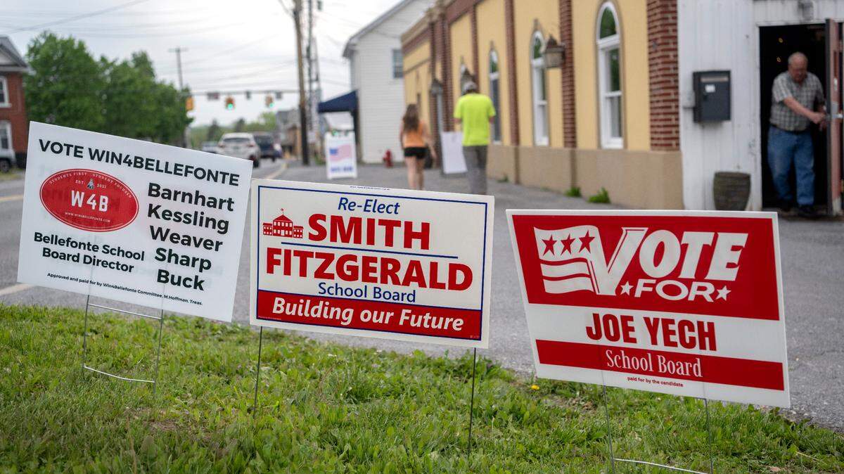 Signs promoting candidates for the Bellefonte school board wave in the wind as voters enter and leave the Spring South precinct for the primary election on Tuesday, May 16, 2023.
