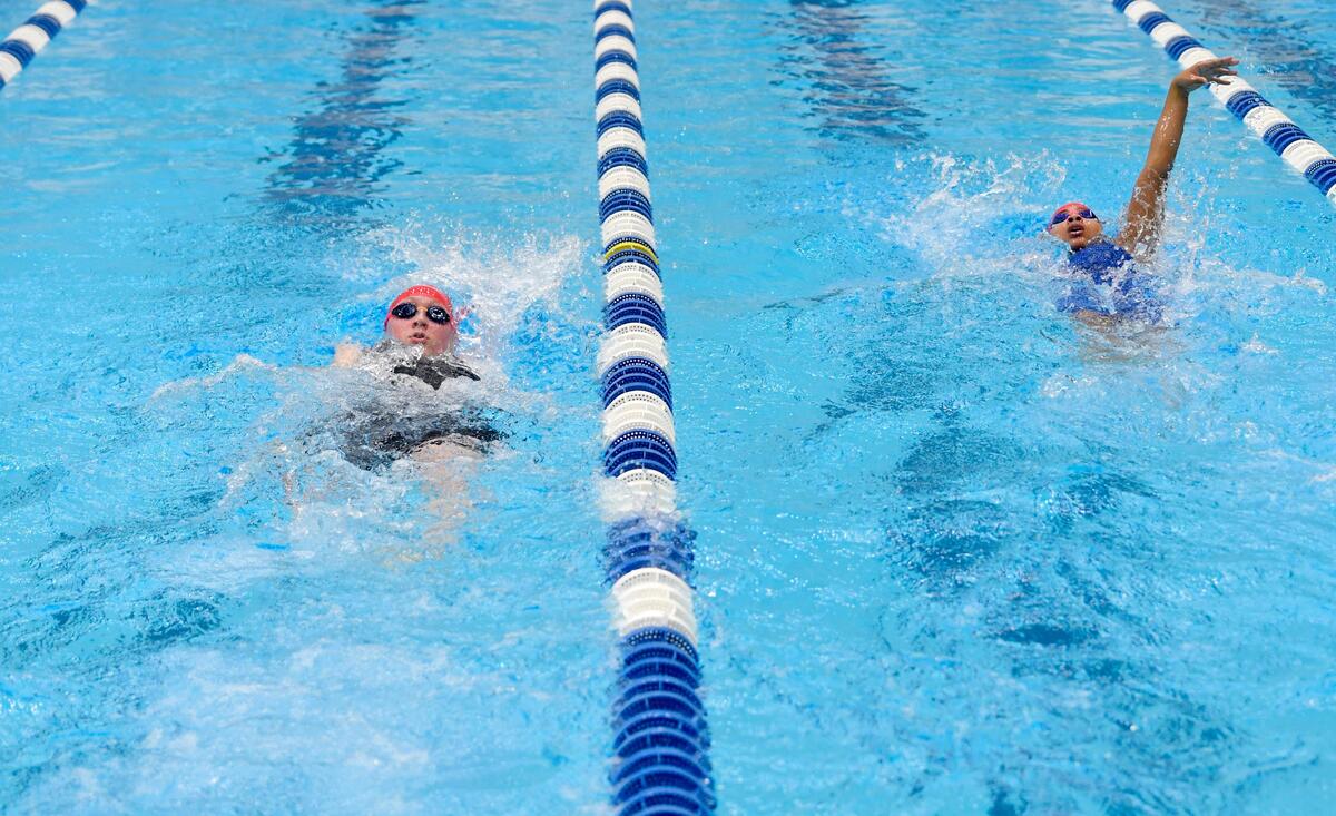 Bellefonte’s Finley Musser and Natasha Hoffman do the backstroke in the girls AA 200 IM during the District 6 swimming championships on Friday, Feb. 28, 2020.
