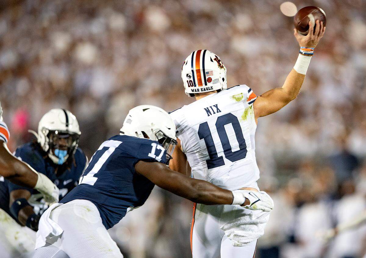 Penn State defensive end Arnold Ebiketie pressures Auburn quarterback Bo Nix as he makes a pass during the game.