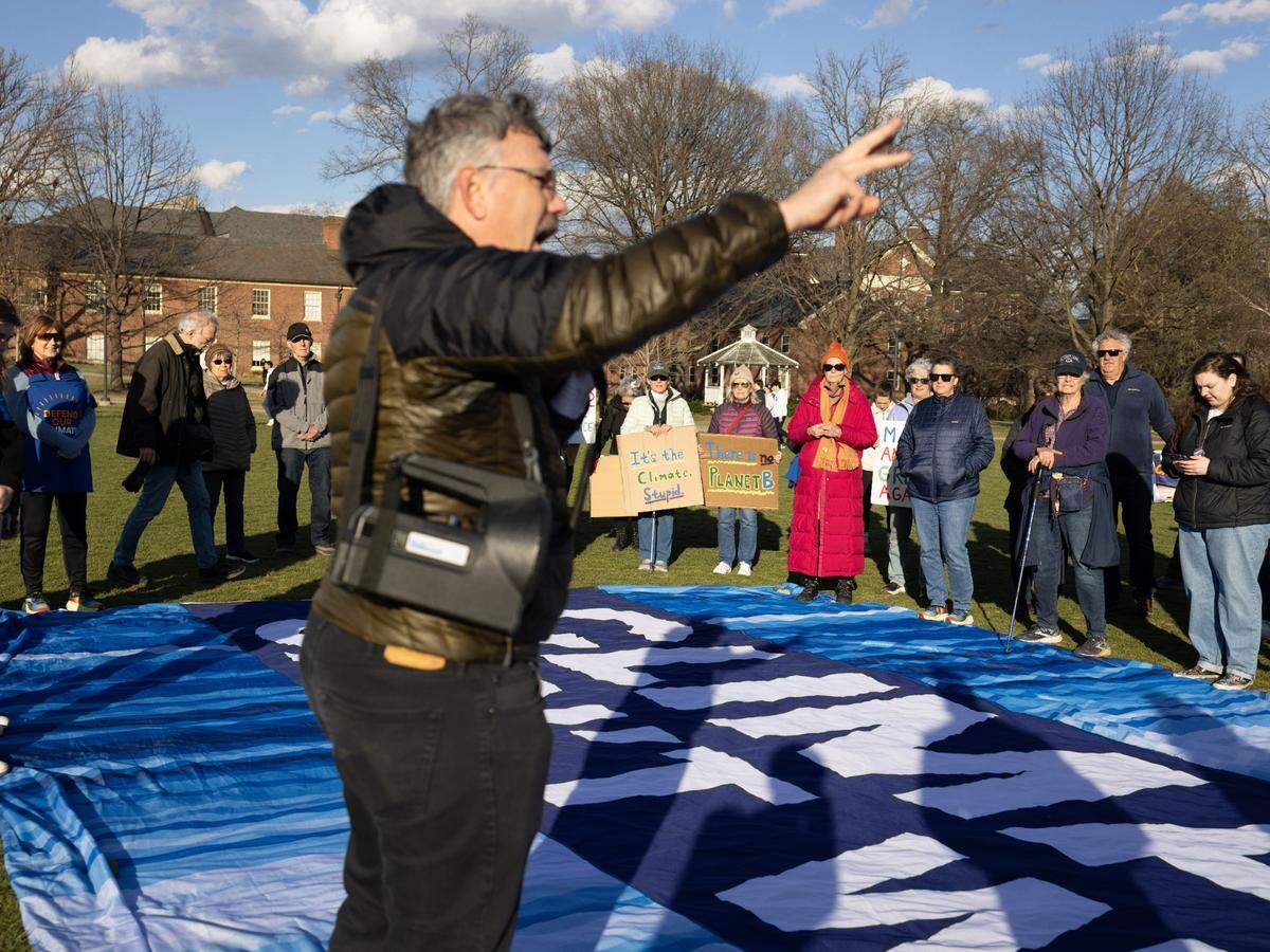 Peter Buck, director of education for Penn State Sustainability, speaks to a crowd gathered on the HUB lawn on Monday, March 24, 2025.