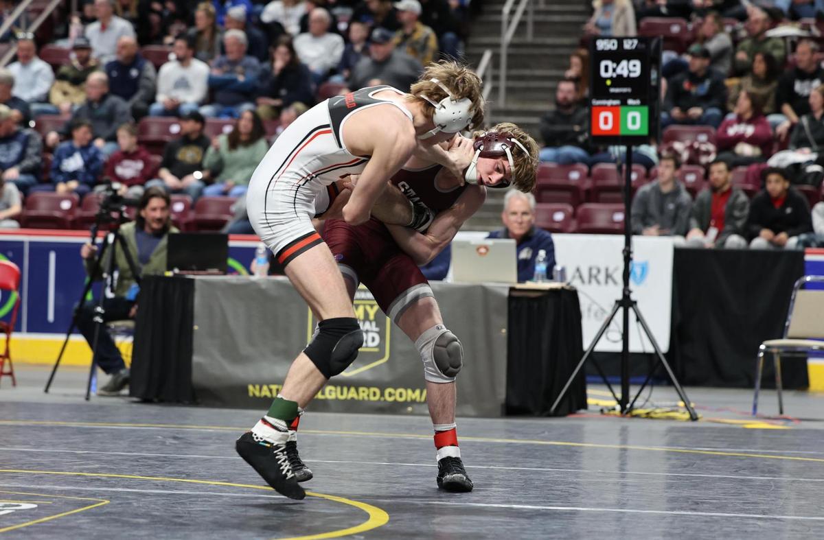 State College’s Hayden Cunningham looks to finish off a takedown of Hempfield’s Seamus Mack in their 127-pound fifth-place match of the PIAA Class 3A Championships on Saturday, March 11, 2023 at the Giant Center in Hershey. Cunningham beat Mack, 7-4.