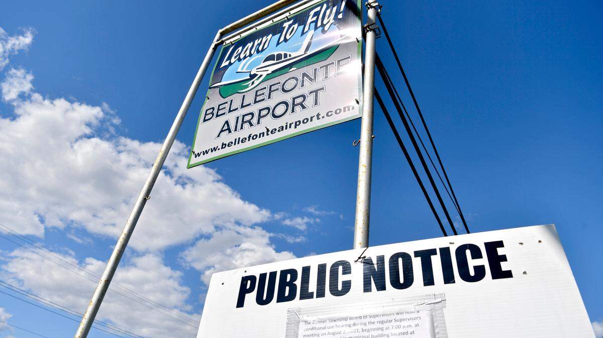A public notice leans against the sign for the Bellefonte Airport on Aug. 2, 2021. Plans to construct a campground at the site were rejected by Benner Township’s supervisors.