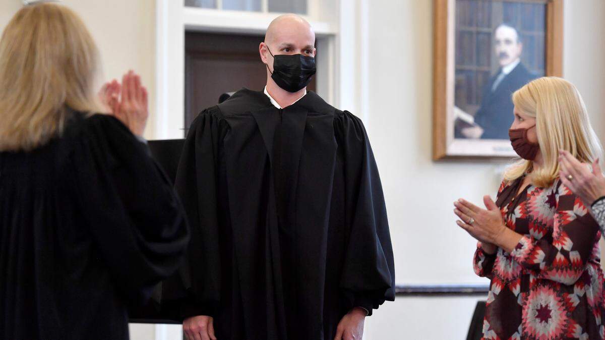 Magisterial district judge Greg Koehle is applauded Monday after being sworn in and putting on his judge’s robe during a ceremony at the Centre County Courthouse.