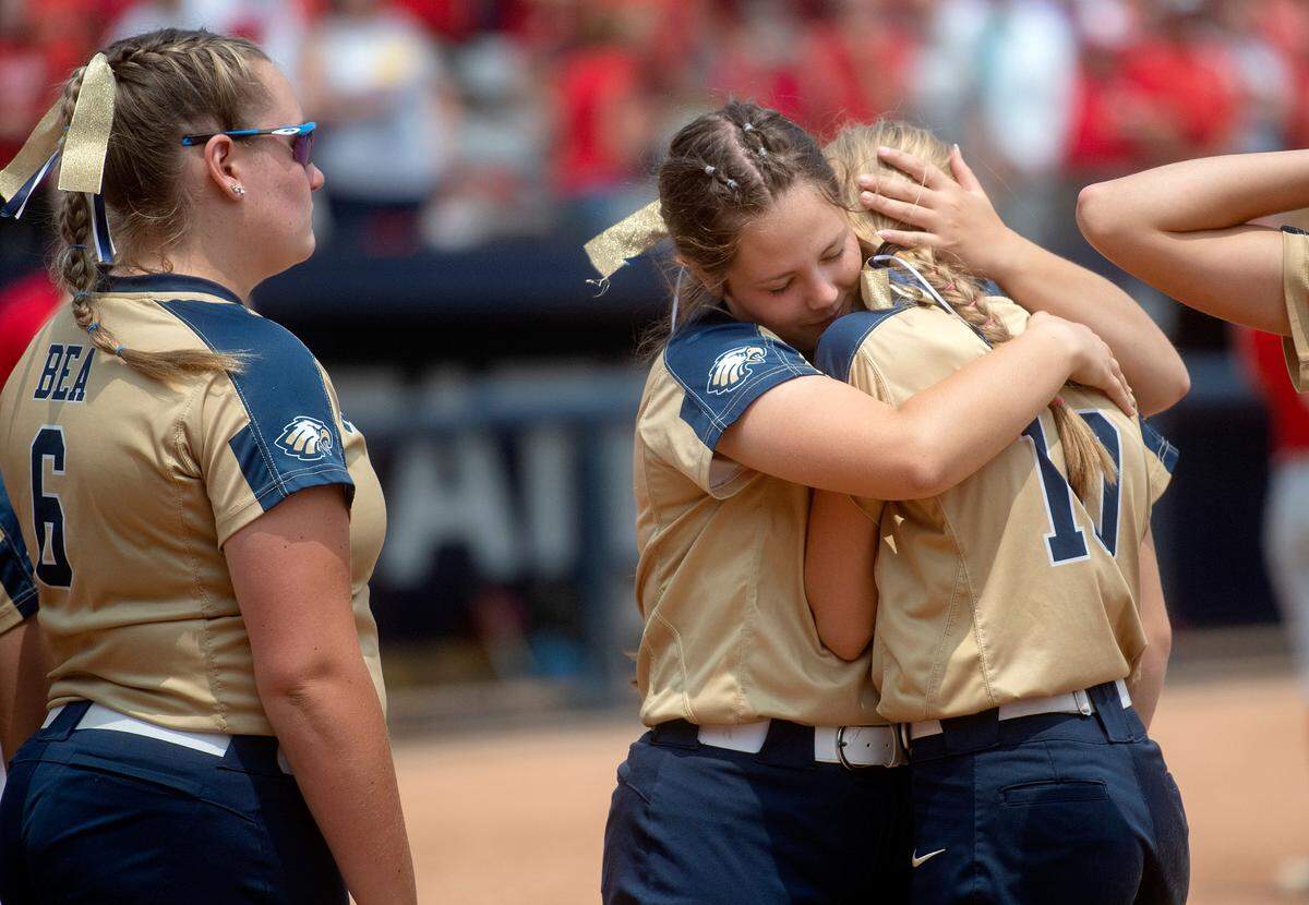 Bald Eagle Area softball players hug after the 12-1 loss to Everett in PIAA class 2A championship game at Beard Field on Thursday, June 15, 2023.