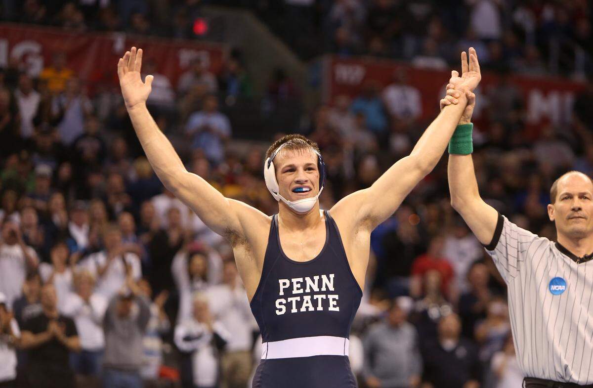 Penn State 165-pounder David Taylor has his hand raised after defeating Tyler Caldwell of Oklahoma State 6-0 to win the national title at the NCAA 2014 Division I Wrestling Championships in the Chesapeake Energy Arena in Oklahoma City, Okla. on Saturday, March 22, 2014. (The Daily Iowan/Tessa Hursh)