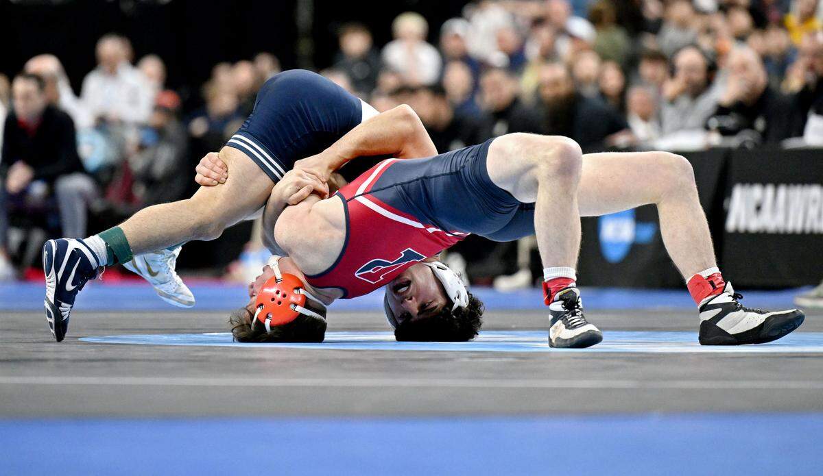 Penn State’s Beau Bartlett controls Penn’s CJ Composto in the 141-pound third place bout of the 2025 NCAA Wrestling Championships in Philadelphia’s Wells Fargo Center on Saturday, March 22, 2025.