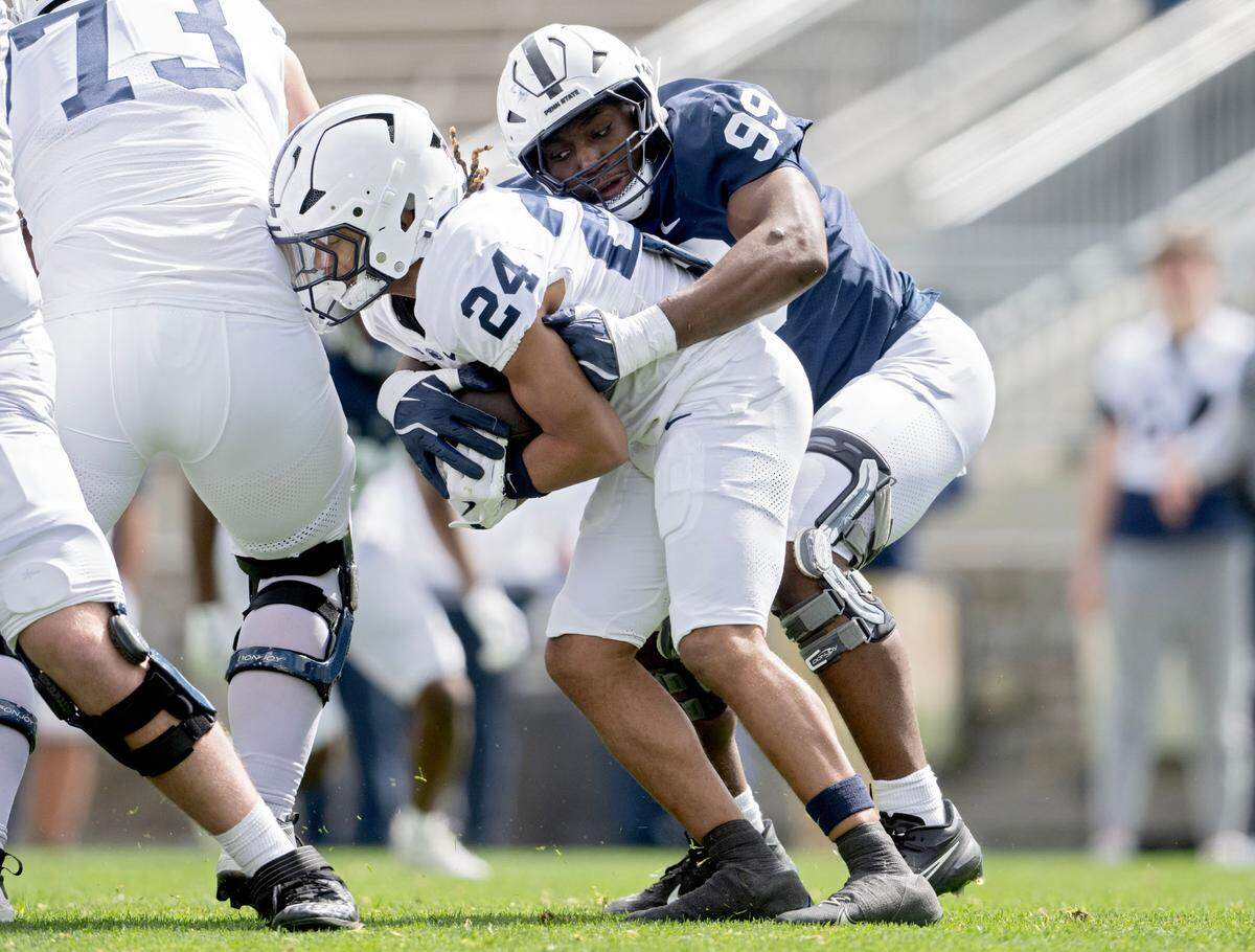 Penn State defensive end Yvan Kemajou stops running back Corey Smith during the Blue-White game on Saturday, April 26, 2025.