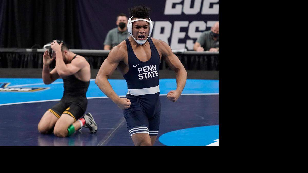 Penn State’s Carter Starocci, right, celebrates after defeating Iowa’s Michael Kemerer during their 174-pound match in the finals of the NCAA wrestling championships Saturday, March 20, 2021, in St. Louis. (AP Photo/Jeff Roberson)