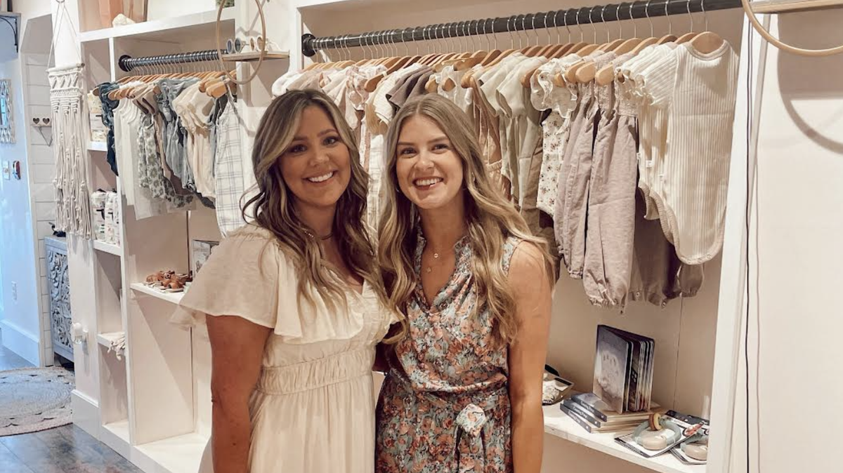 Owner Emily Boone, left, poses with manager Amelia Tyler, right, inside their new Thread Baby Boutique.