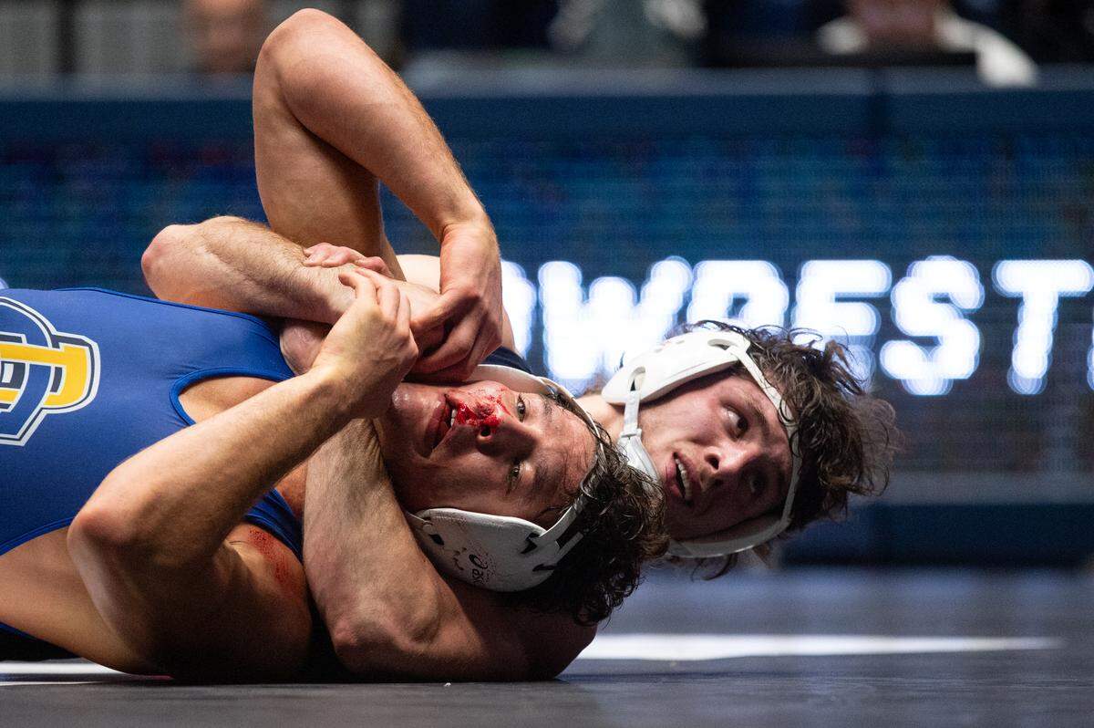 Levi Haines, right, wrestles Cade Devos, left, in a 174-pound bout during the NWCA All-Star Classic at Rec Hall on Saturday, Nov. 16, 2024. Haines won the bout 7-0.