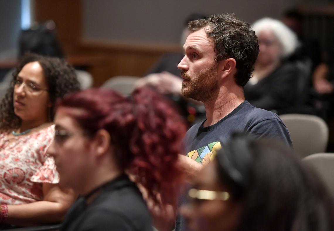 Community members question the results of the internal investigation in the shooting of Osaze Osagie at an August meeting.