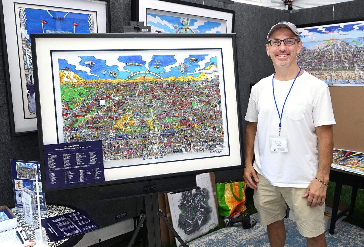 Stephen Szynal of Steve Szynal Design stands by one of his largest art works at the 57th Central Pennsylvania Festival of the Arts in State College Thursday, July 13, 2023. (For the CDT/Steve Manuel)