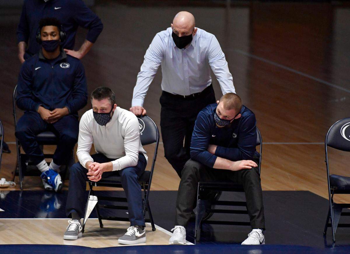 Penn State wrestling coaches, Cael Sanderson, Cody Sanderson and Jake Varner watch the match against Maryland on Monday, Feb. 22, 2021.