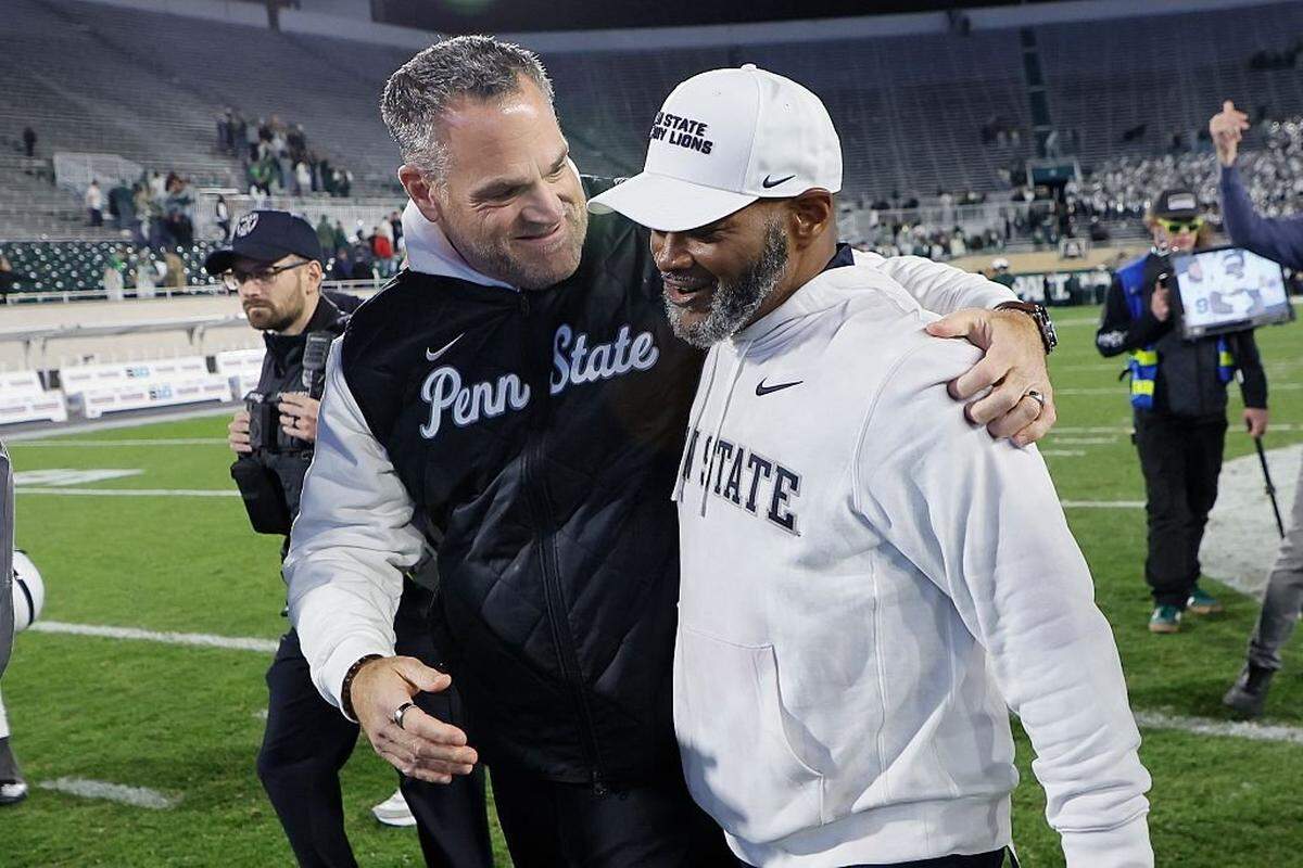 EAST LANSING, MICHIGAN - NOVEMBER 15: Penn State Athletic Directer Patrick Kraft, left, hugs Interim Head coach Terry Smith after a win over the Michigan State Spartans at Spartan Stadium on November 15, 2025 in East Lansing, Michigan. (Photo by Duane Burleson/Getty Images)