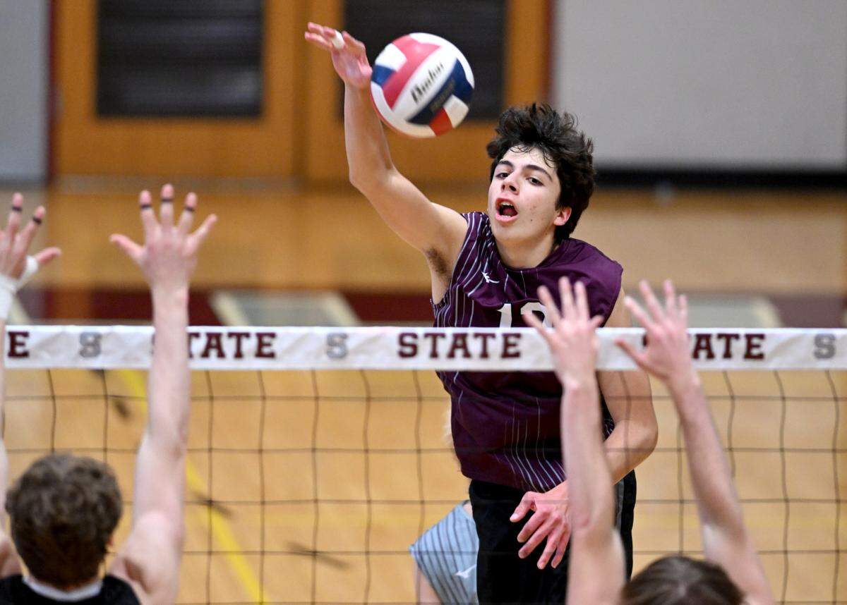 State College’s Kadin Karaky hits the ball past Central Dauphin defenders during the boys volleyball game on Wednesday, May 10, 2023.
