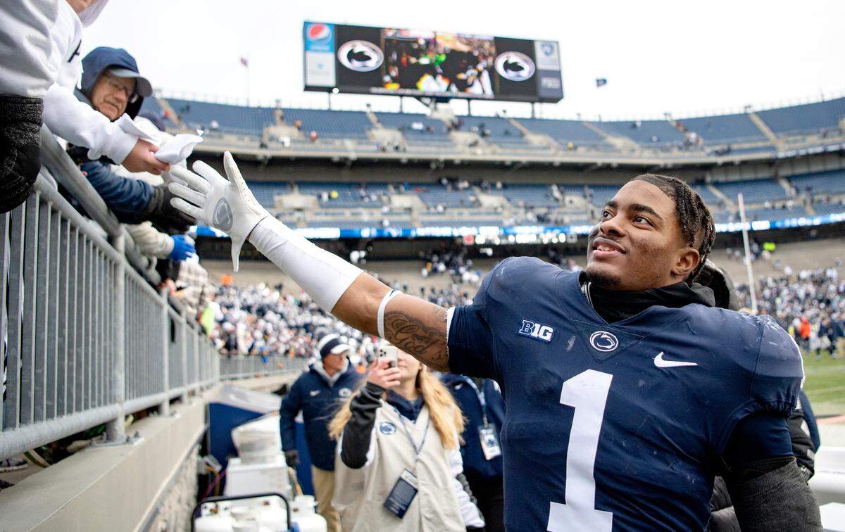 Penn State safety Jaquan Brisker high-fives fans after the win over Rutgers on Saturday, Nov. 20, 2021.