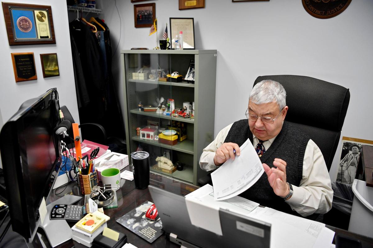 District Judge Carmine Prestia Jr. signs off on paperwork in his office on Tuesday Dec. 31, 2019, days before his term will end.