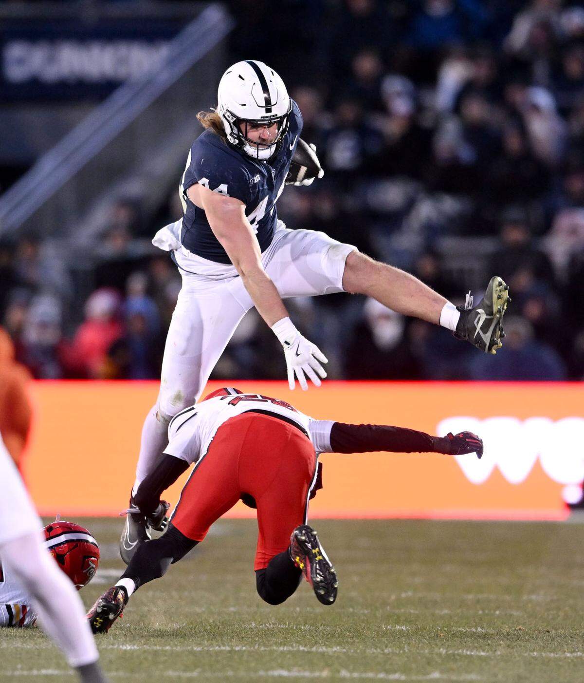 Penn State tight end Tyler Warren leaps over Maryland’s Kevis Thomas during the game on Saturday, Nov. 30, 2024.  
