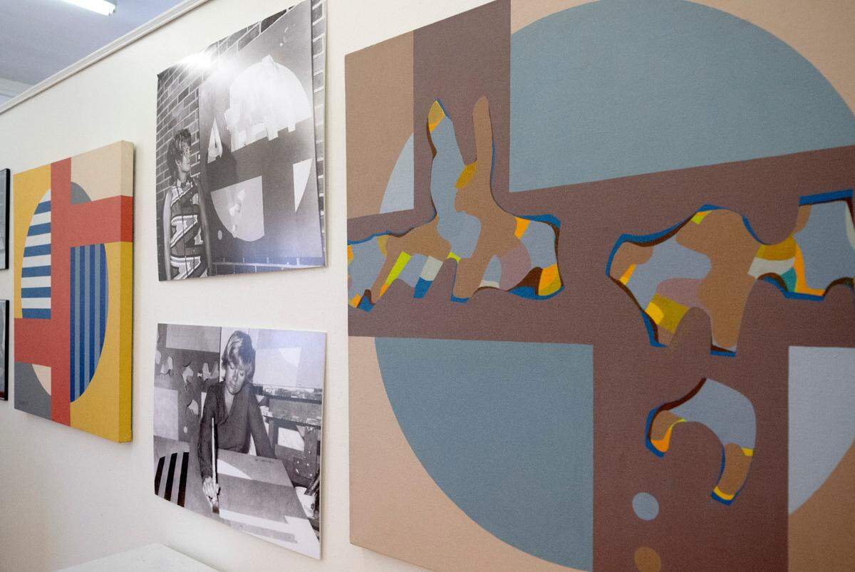 Portraits of Deanna Blumenthal hang among her artwork at the The Art Alliance of Central Pennsylvania on Thursday. The Art Alliance is celebrating its 55th anniversary with an exhibit featuring a founder, Bluementhal, and current abstract artists.