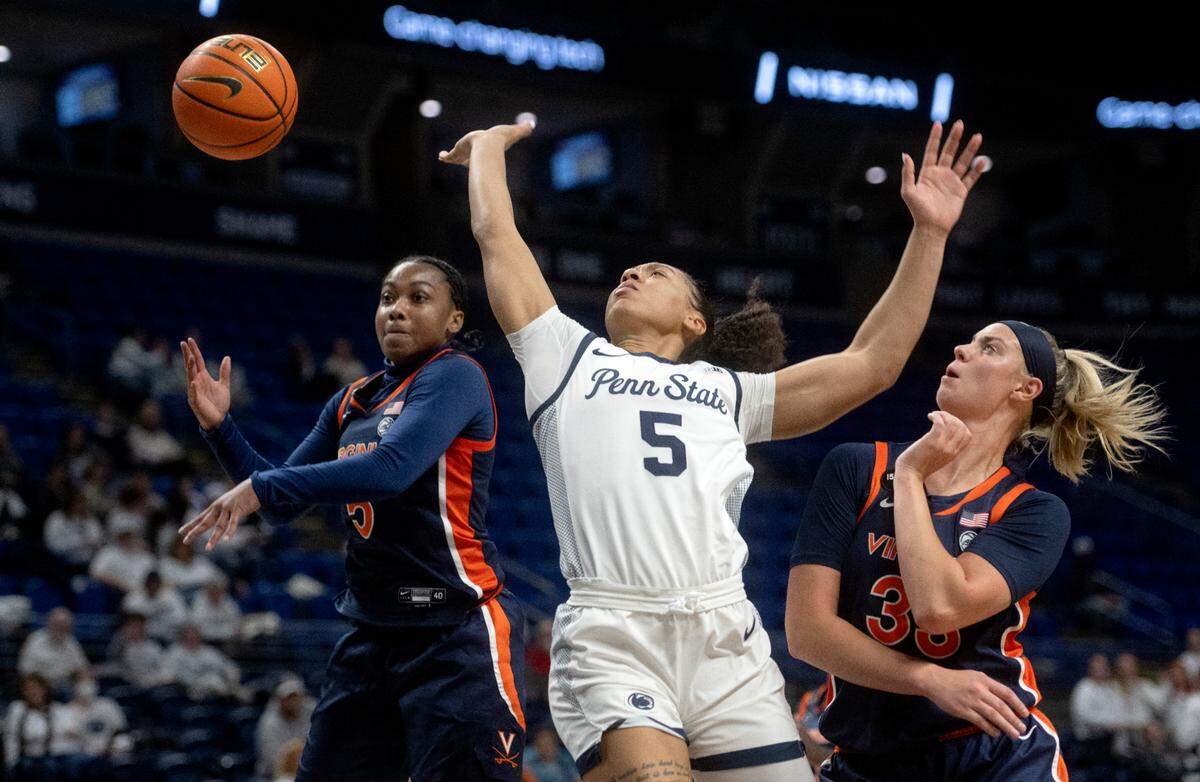 Virginia defenders knock the ball away from Penn State’s Leilani Kapinus during the game on Wednesday, Nov. 30, 2022.